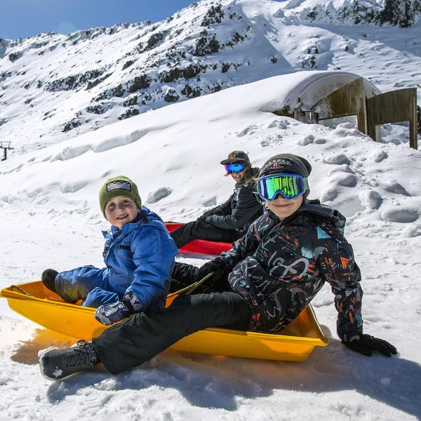 Tobogganing down the slopes at Whakapapa