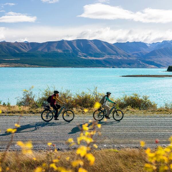 Cyclist passing by Lake Takapō on the Alps 2 Ocean Cycle Trail