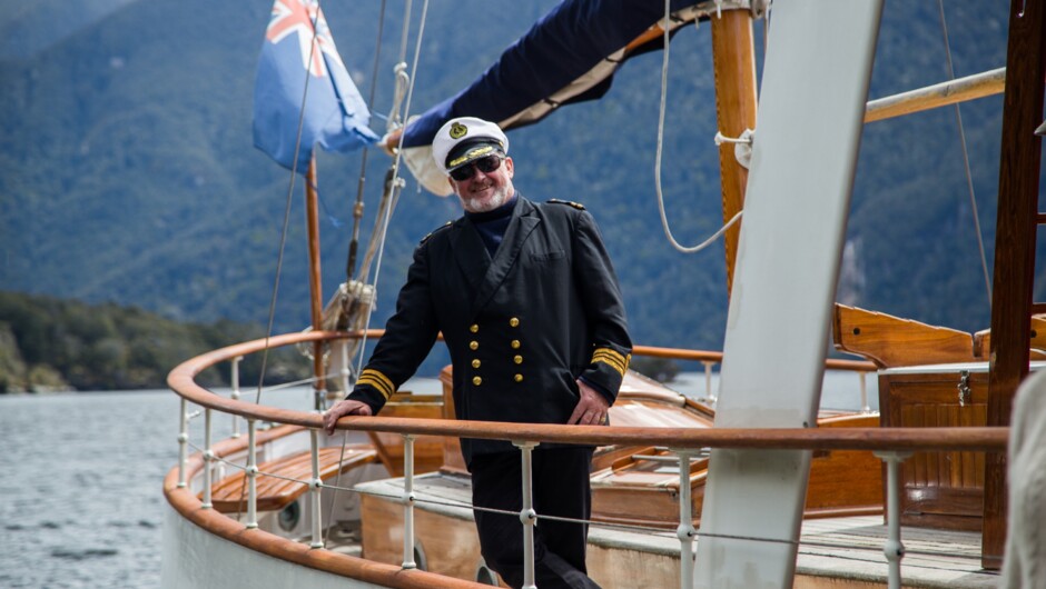 Captain Max in his finest. He'll have the tea ready, with drinks and canapes when you return from your walk in the Fiordland National Park.