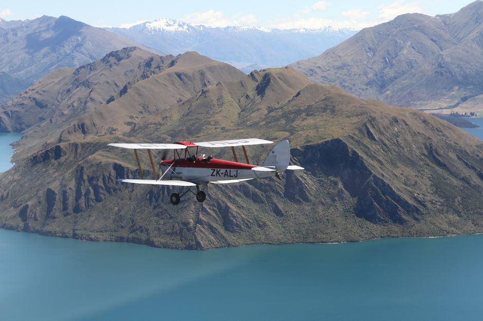 ZK-ALJ takes a flight over the lake at Wanaka.