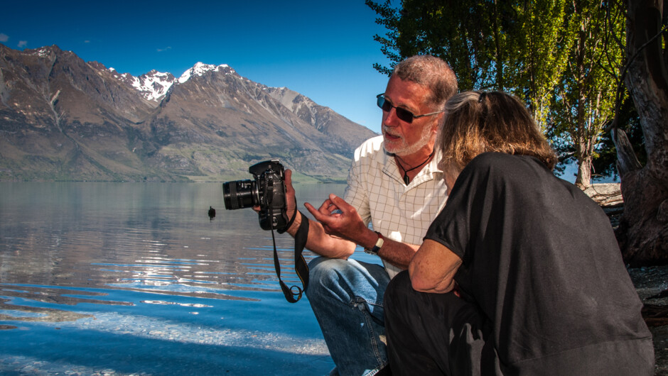Laurence Belcher gives advice to a photo tour client at Little Paradise on Queenstown's Lake Wakatipu near Glenorchy.