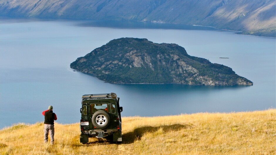 Taking in the views over Lake Wanaka and Mou Waho Island from Ridgeline Adventures 4WD farm safari high in the hills.