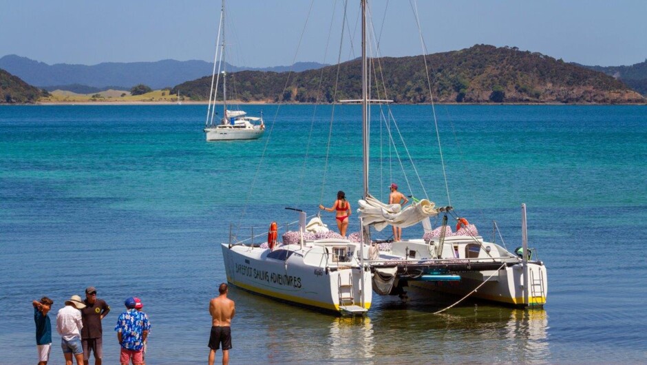The catamaran anchors right up close on the shore line, ready for your island adventures.