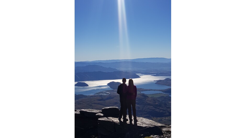 View from Summit, couple taking in the spectacular views over Lake Wanaka