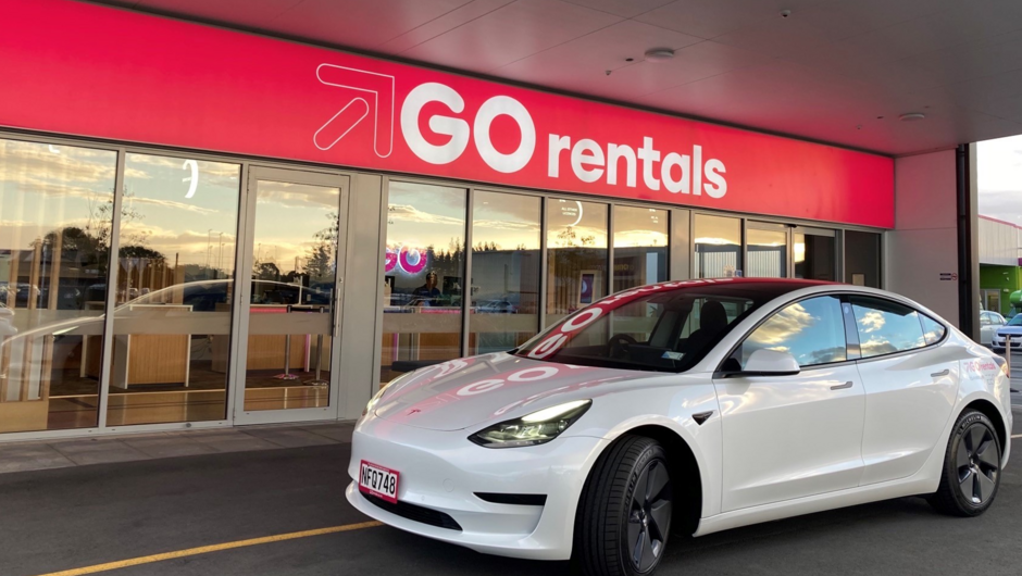 Tesla Model 3 vehicle in front of GO Rentals branch.