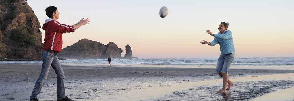 Playing around on Piha beach, Auckland