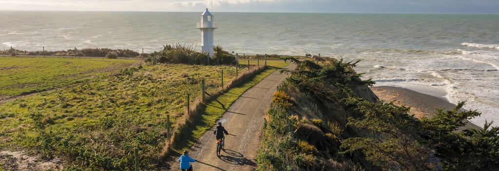 People riding bikes at Jack's Point Lighthouse, Timaru