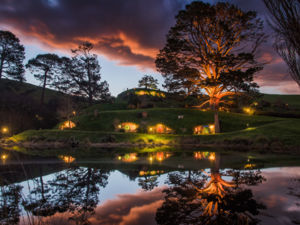 The Hobbiton™ Movie Set in the lush countryside setting of Matamata is a spectacular sight at sunrise or sunset.