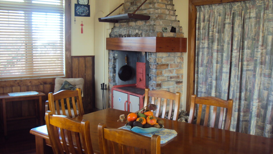 Wharf Hub kitchen dinning area with wood stove in Winter