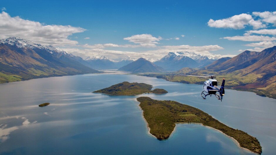 Heli Glenorchy EC-120 helicopter flying towards Glenorchy over Pigeon & Pig Islands