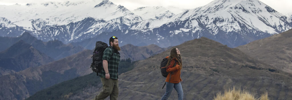 Hikers enjoying view of snow capped mountains on Queenstown Hill track