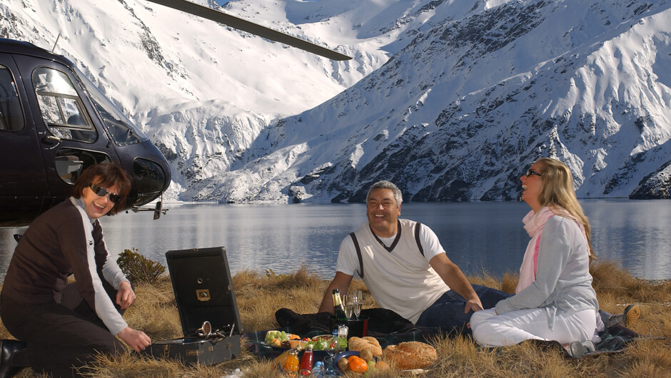 Guests enjoying a picnic beside an Alpine Lake