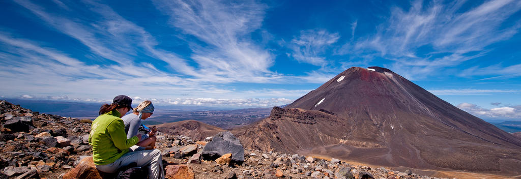 The plateau rest stop at the highest point of the Tongariro Alpine Crossing is a chance to grab a snack and take in the stunning scenery.