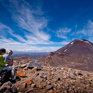 The plateau rest stop at the highest point of the Tongariro Alpine Crossing is a chance to grab a snack and take in the stunning scenery.