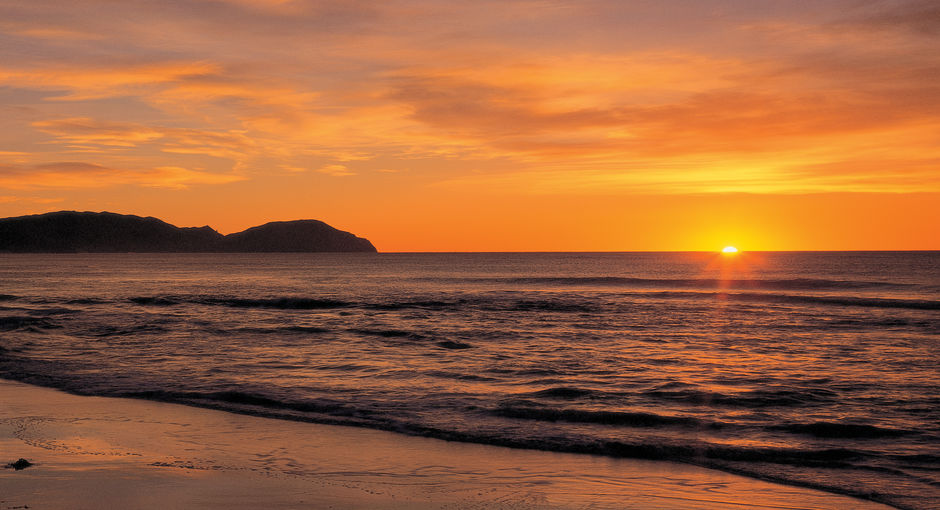 Beautiful Wainui Beach is a place to catch waves and sunrises.