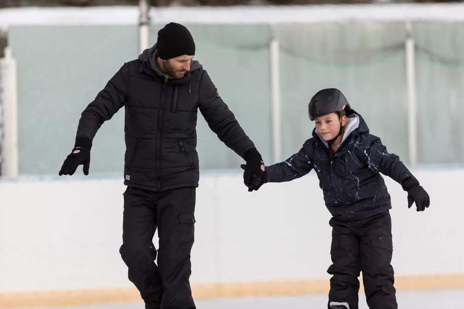 Father and son ice skating at Tekapo Springs ice rink