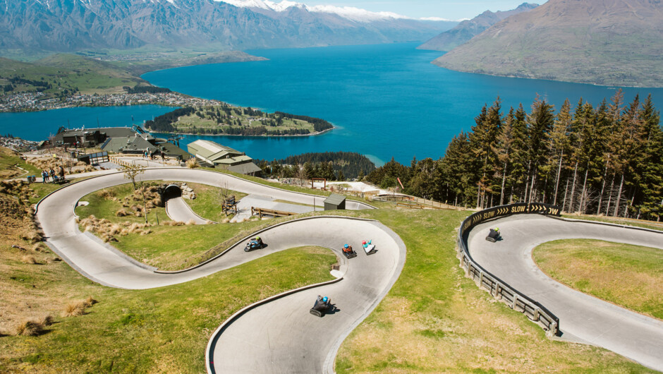 A panoramic view of both Luge tracks with Lake Wakatipu and the Remarkables behind.