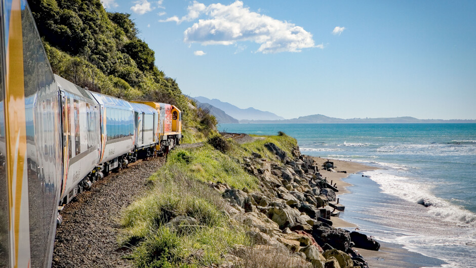 Squeezing between mountains and sea, the Coastal Pacific train travels along Kaikoura's rugged and remote coastlines