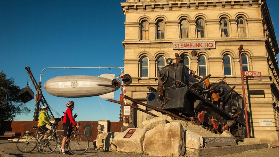 Cyclists checking out the Steampunk in Oamaru on Adventure South's Alps to Ocean tour.