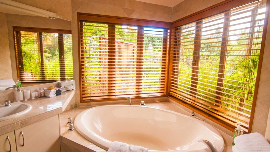 Premium suite bathroom offers a deep relaxation bath, separate spacious shower, and walk-in robes.
