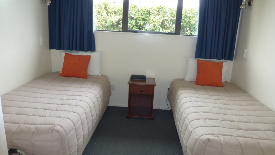 Twin Single Beds in Three bedroom Motel Room
