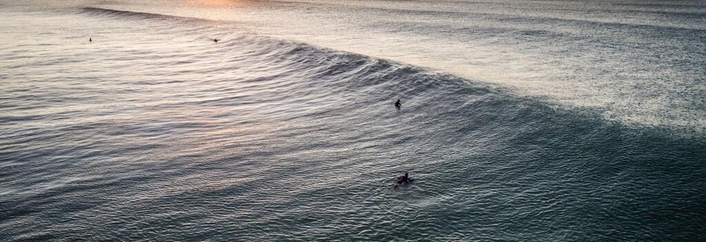 Surfing at sunset