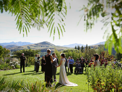 Choose to say &#039;I do&#039; amidst our stunning gardens and share a moment that you will remember for a lifetime, surrounded by majestic oaks and tranquil water features, with the unmistakable backdrop of the lake and mountains silhouetted against the sky.
