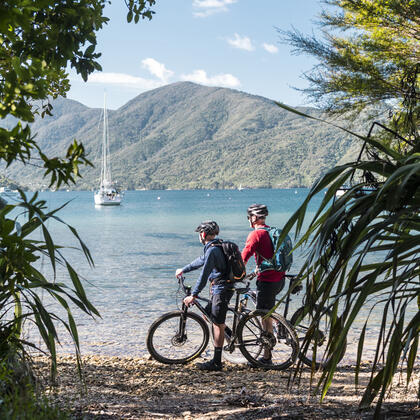 Bikers admiring the scenic water views along the Queen Charlotte Track