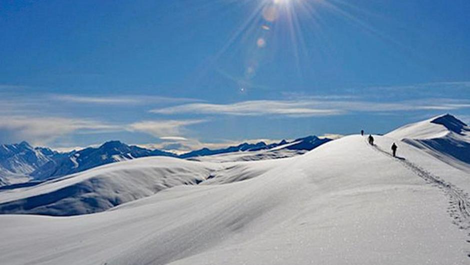 Nordic skiers ascend Snake Ridge en route to Beuzenberg Peak in the Two Thumb Range, Kahui Kaupeka Conservation Park.