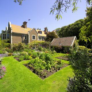 Visit Olveston Historic House and Gardens in Dunedin.