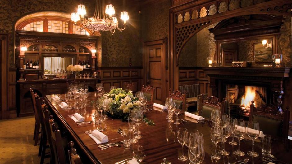 The Dining Room at Otahuna Lodge features original gilded, Victorian wallpaper and a roaring fire. Guest can dine communally here or in a range of private locations around the estate.