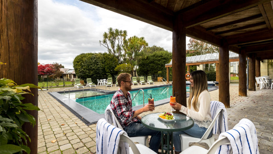 Dining poolside at Distinction Te Anau Hotel &amp; Villas