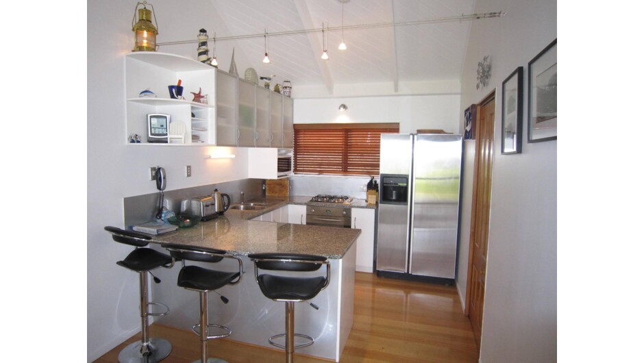 Fully equipped kitchen with ice maker, twin dish drawer dishwashers and granite breakfast bar