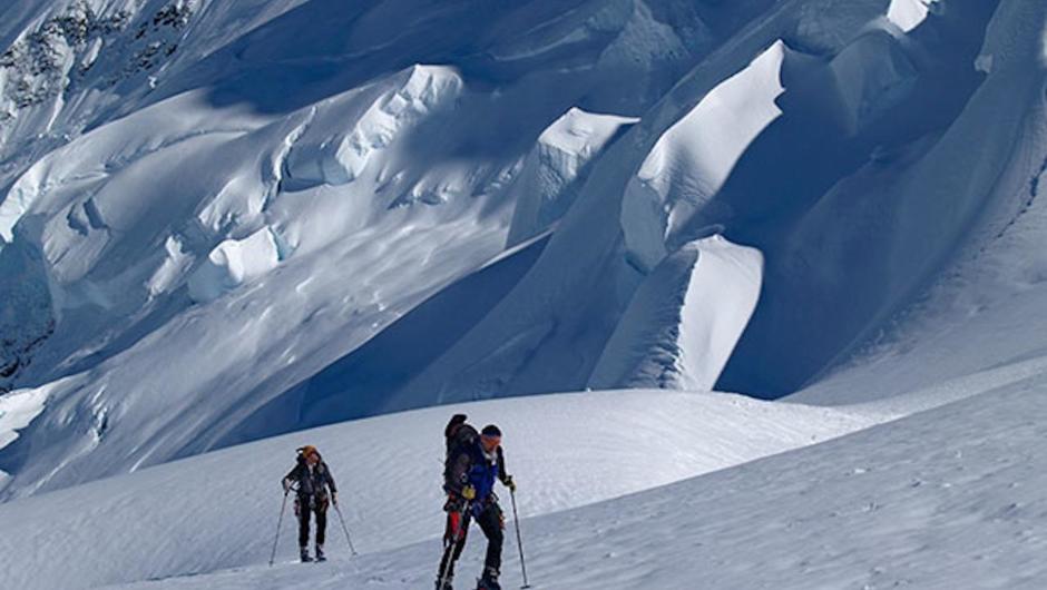 Alpine ski tourers ascend the Brodrick Ramp at the head of the Tasman Glacier