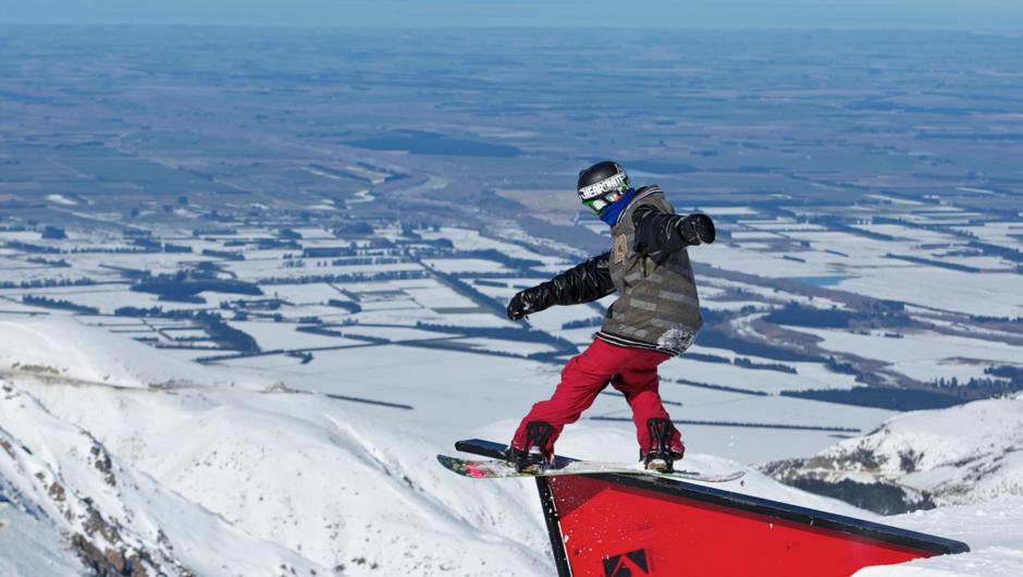 A snowboarder practices his technique on a rail in the Mt Hutt terrain park.