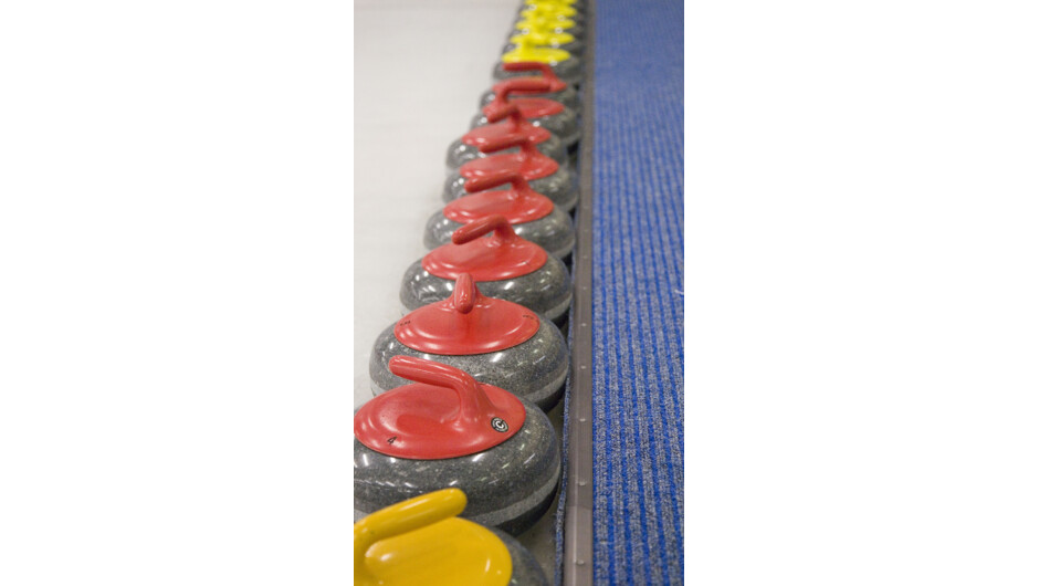 A line up of curling stones waiting for you.