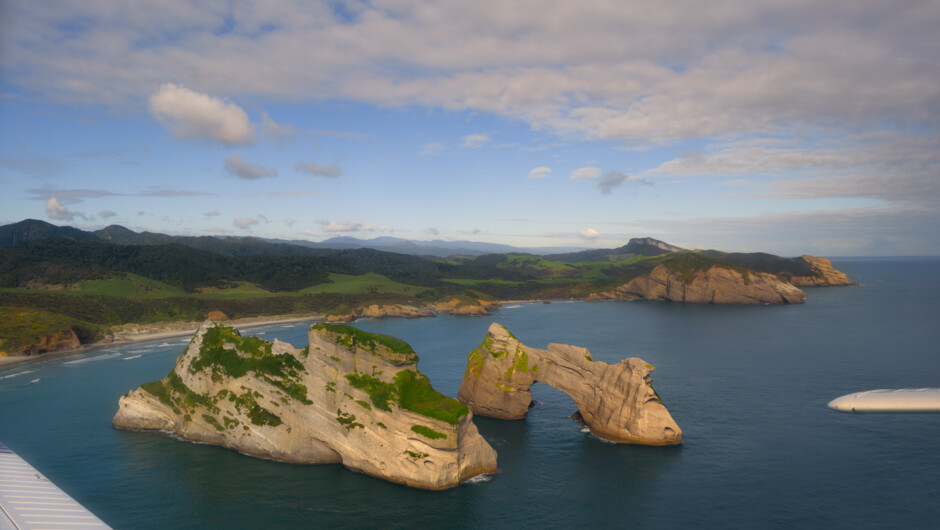 The famous Wharariki Beach arches from Golden Bay Air&#039;s West Coast and Farewell Spit scenic flight