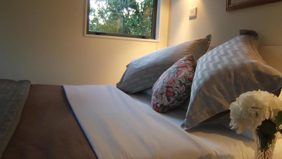 Queen beds with high quality linen, duvets and wool blankets.  Listen to the stream from one of the windows.