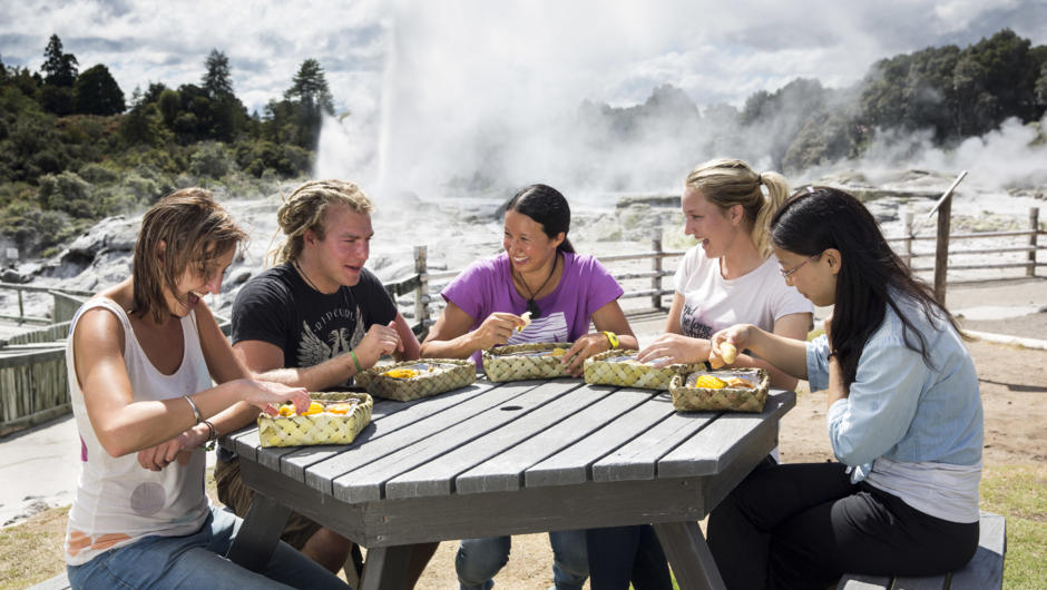 Enjoying steam box lunch at picnic table overlooking Pohutu geyser