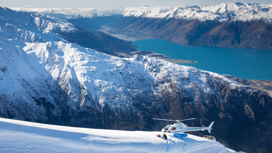 Helicopter with heliskiers overlooking Lake Wanaka in NZ