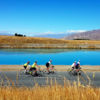 Road cycling next to the turquoise Twizel Canals