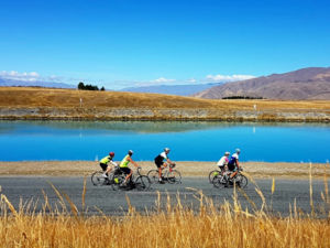 Road cycling next to the turquoise Twizel Canals
