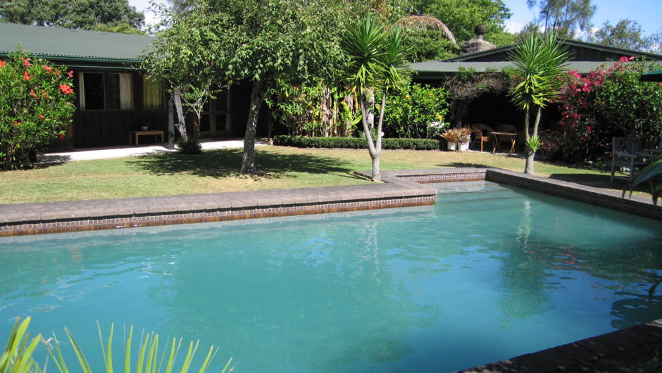View of swimming pool showing garden cottage and patio