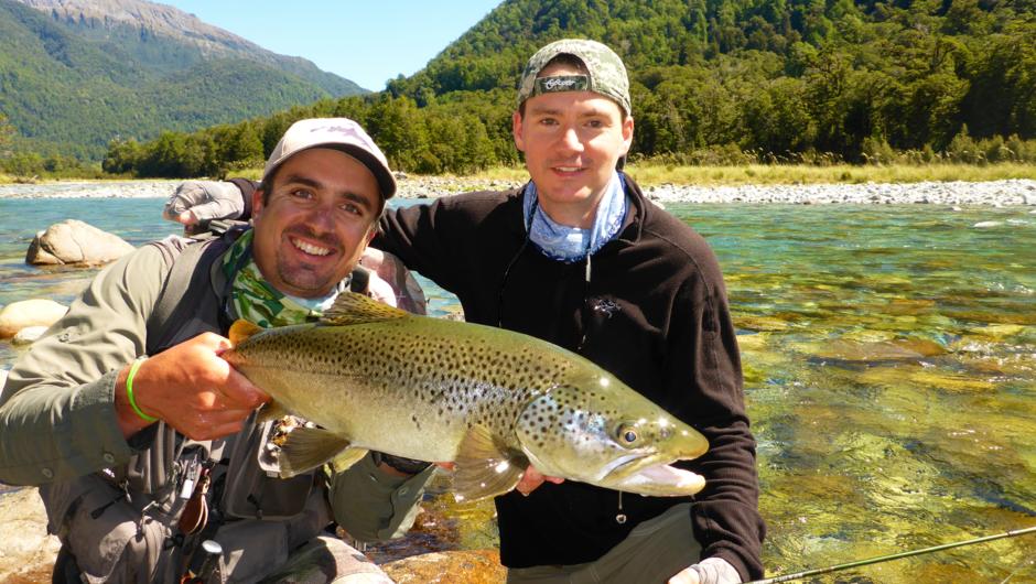 Guide Jake and client Joe with Joe&#039;s trophy New Zealand brown trout