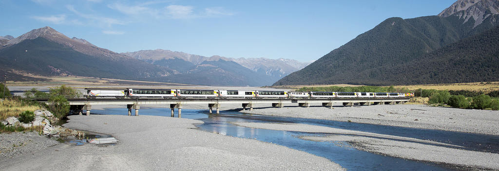 Experience the natural beauty of the South Island on the TranzAlpine.  Seen here crossing the Waimakariri River near Cass