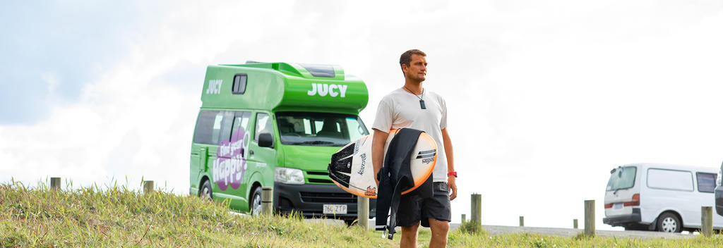 Jucy campervan and surfer 