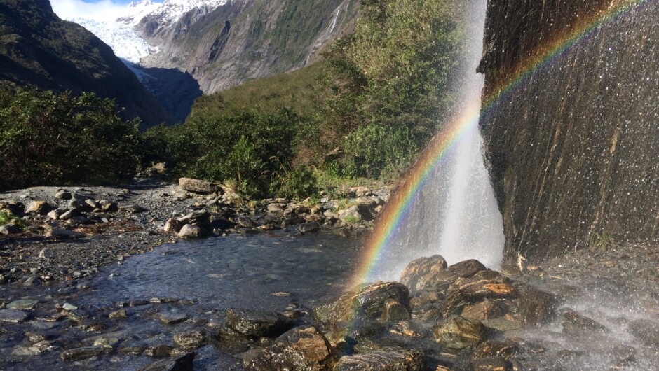 Rainbows in Trident Falls waterfall in the Franz Josef Glacier Valley