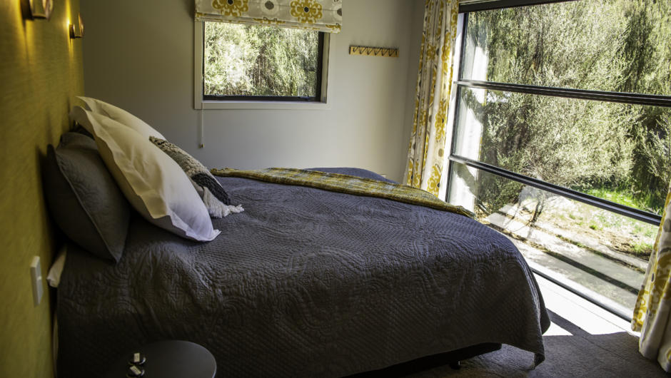 Both bedrooms have full height windows to enjoy the bush views from.