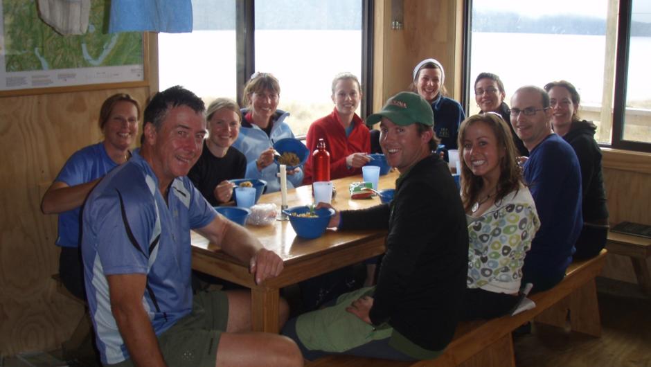 Group enjoying a meal at the hut