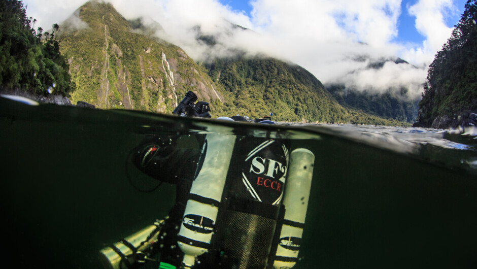 The gateway between worlds. SF2 Rebreather diver descending into Milford Sound.